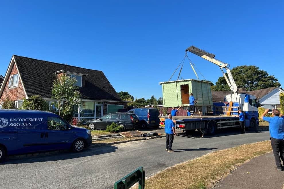 Summer house being removed from a house