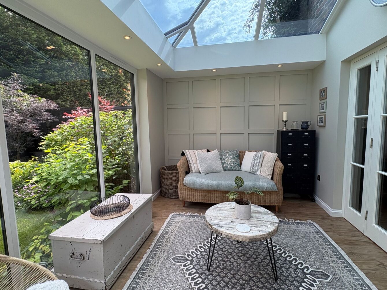 Evening view of the internal hup! extension, showing downlights on the panelled wall.